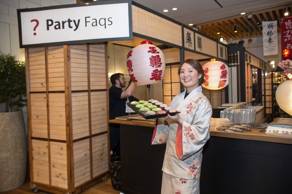 A friendly Q&A booth showcasing commonly asked queries about Japanese party food, emphasizing the variety and approachability of these dishes.