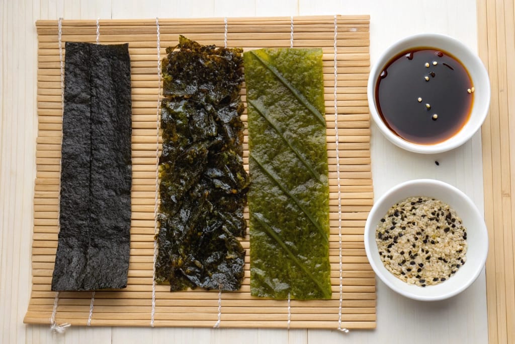 Kombu, wakame, and nori arranged to highlight their unique textures and hues, underscoring their importance in Japan’s sea vegetable tradition.