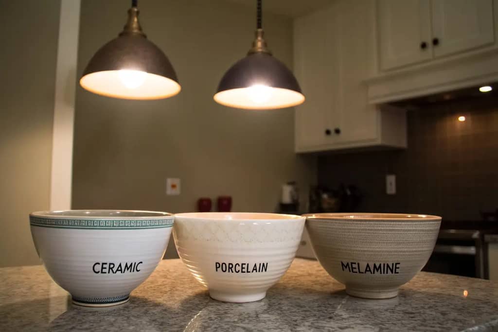  Three large ramen bowls made of different materials—ceramic, porcelain, and melamine—showing variations in texture, gloss, and thickness.